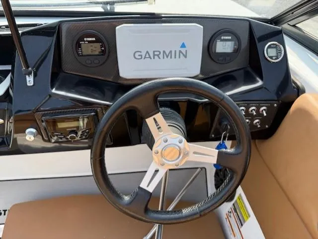 Slide: The Image of Steering wheel and dashboard of 2021 Glastron GTD 240 boat with Garmin display. - 9
