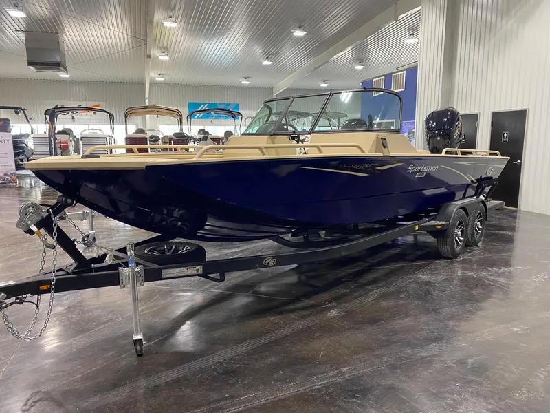 Slide: The Image of 2025 G3 Sportsman 2400 boat displayed indoors on a trailer. - 2