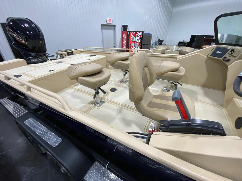 Slide: The Image of 2025 G3 Sportsman 2400 boat interior with beige seating and modern design. - 7
