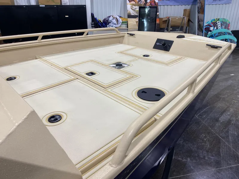 Slide: The Image of 2025 G3 Sportsman 2400 boat deck with storage compartments and railings. - 9