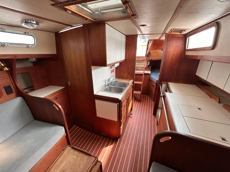 Slide: The Image of Interior of 1983 Sabre 38 sailboat with wood finish and compact kitchen area. - 11