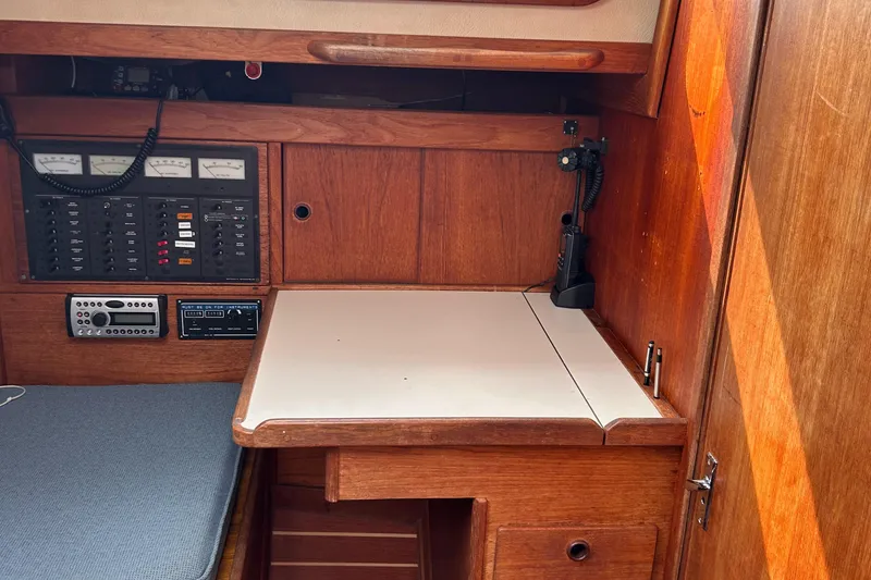 Slide: The Image of 1983 Sabre 38 yacht interior with navigation station and control panels. - 16