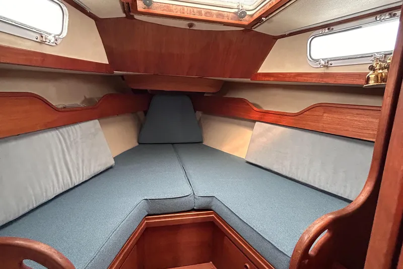 Slide: The Image of Interior cabin of a 1983 Sabre 38 sailboat with cozy blue cushions. - 19