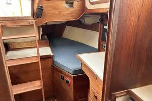 Slide: The Image of Interior of 1983 Sabre 38 sailboat with wooden cabinetry and cozy sleeping area. - 22