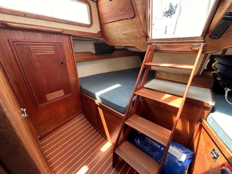 Slide: The Image of Interior of 1983 Sabre 38 sailboat with wooden finish and ladder to deck. - 24