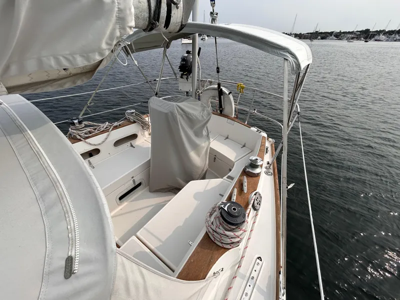 Slide: The Image of 1983 Sabre 38 sailboat cockpit with covered helm, docked on calm water. - 27