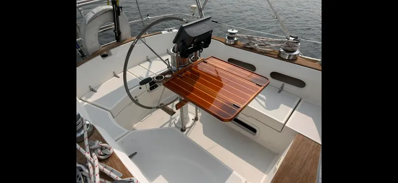 Slide: The Image of Cockpit of 1983 Sabre 38 sailboat with wooden table and steering wheel. - 35