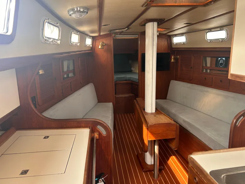 Slide: The Image of Interior of 1983 Sabre 38 sailboat with wooden finishes and cozy seating. - 7