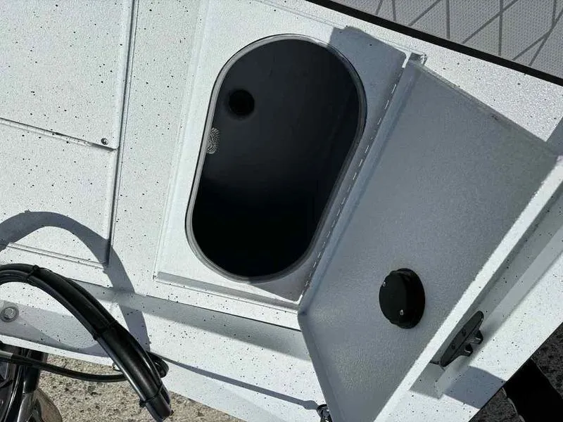 Slide: The Image of Open storage compartment on 2026 Xpress H190B boat, showing interior details. - 11