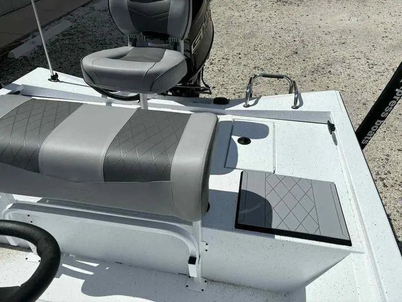 Slide: The Image of 2026 Xpress H190B boat interior with gray seating and storage compartments. - 12