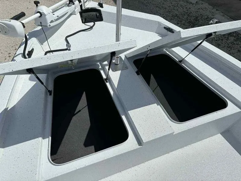 Slide: The Image of Open storage compartments on a 2026 Xpress H190B boat deck. - 14