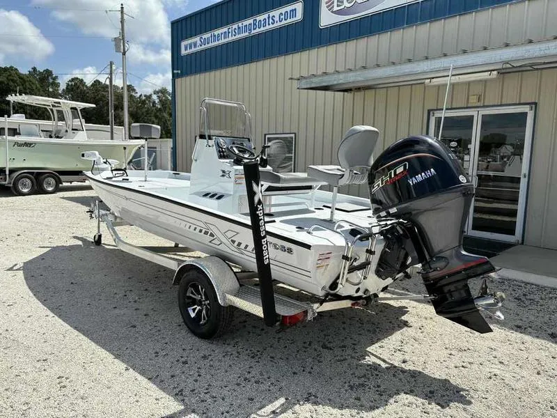 Slide: The Image of 2026 Xpress H190B boat with Yamaha engine, parked outside Southern Fishing Boats dealership. - 2