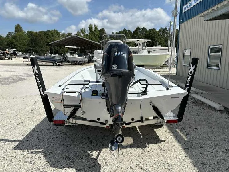 Slide: The Image of 2026 Xpress H190B boat with 115 HP engine, parked outdoors on gravel. - 3