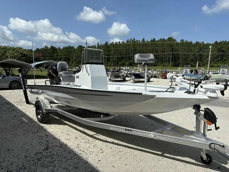 Slide: The Image of 2026 Xpress H190B boat on trailer, parked outdoors under a clear sky. - 6
