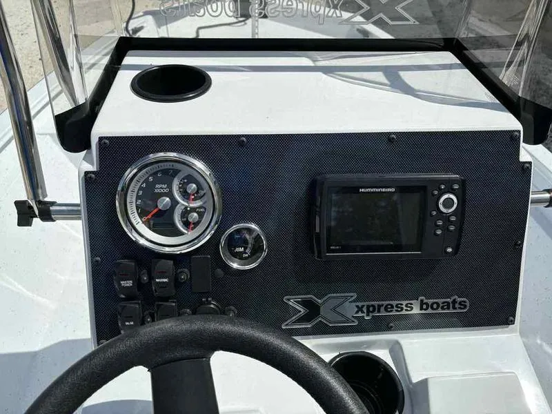Slide: The Image of 2026 Xpress H190B boat dashboard with gauges and navigation system. - 9