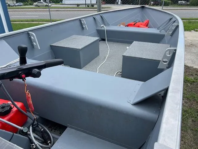 Slide: The Image of 2024 Starcraft Alaskan 13 DLX boat interior with seating and safety equipment. - 3