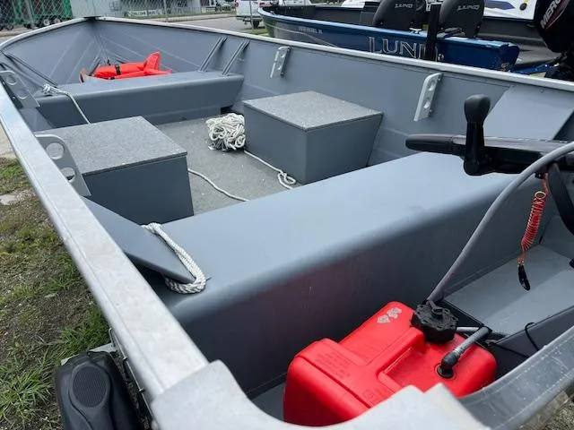 Slide: The Image of 2024 Starcraft Alaskan 13 DLX boat interior with red fuel tank and seating. - 4