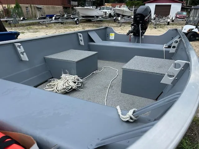 Slide: The Image of 2024 Starcraft Alaskan 13 DLX boat interior with motor and storage compartments. - 5