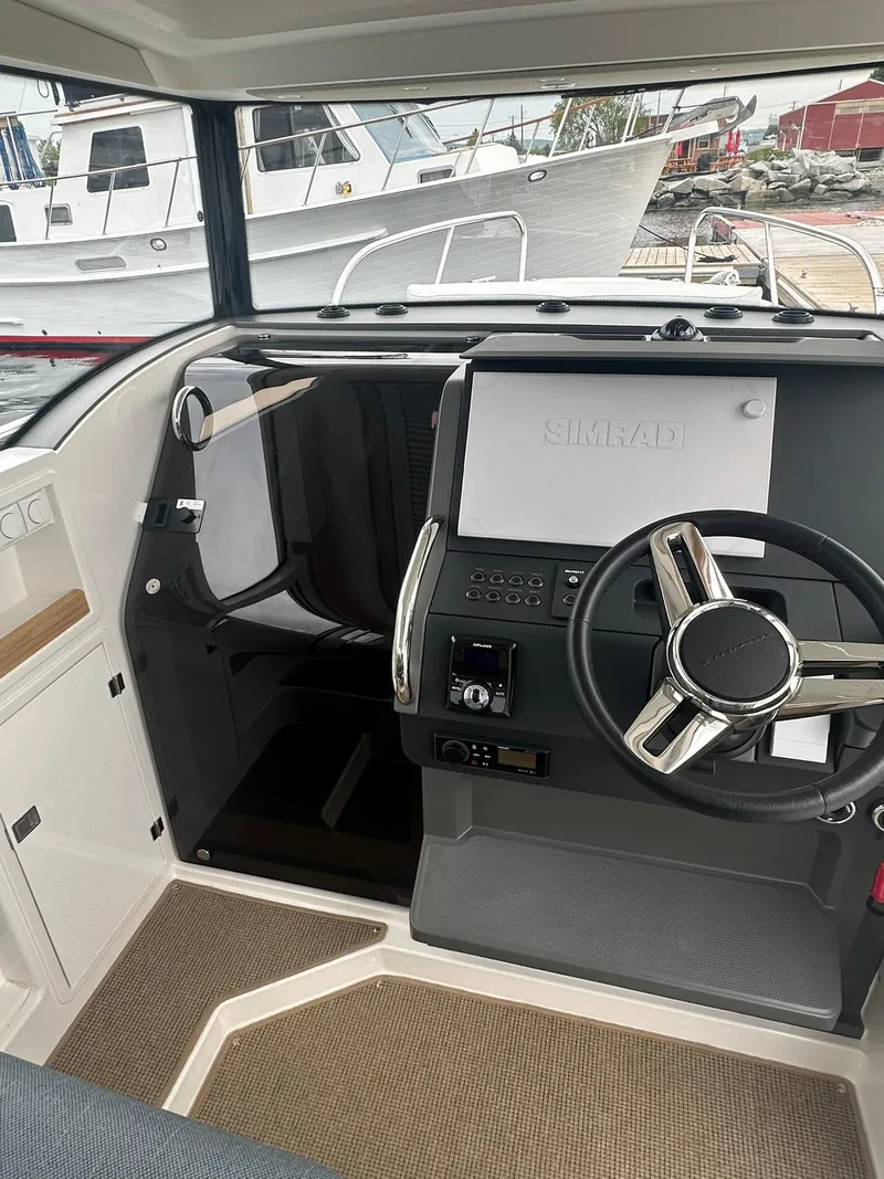 Slide: The Image of 2023 Nimbus Commuter 9 boat interior with steering wheel and control panel. - 12