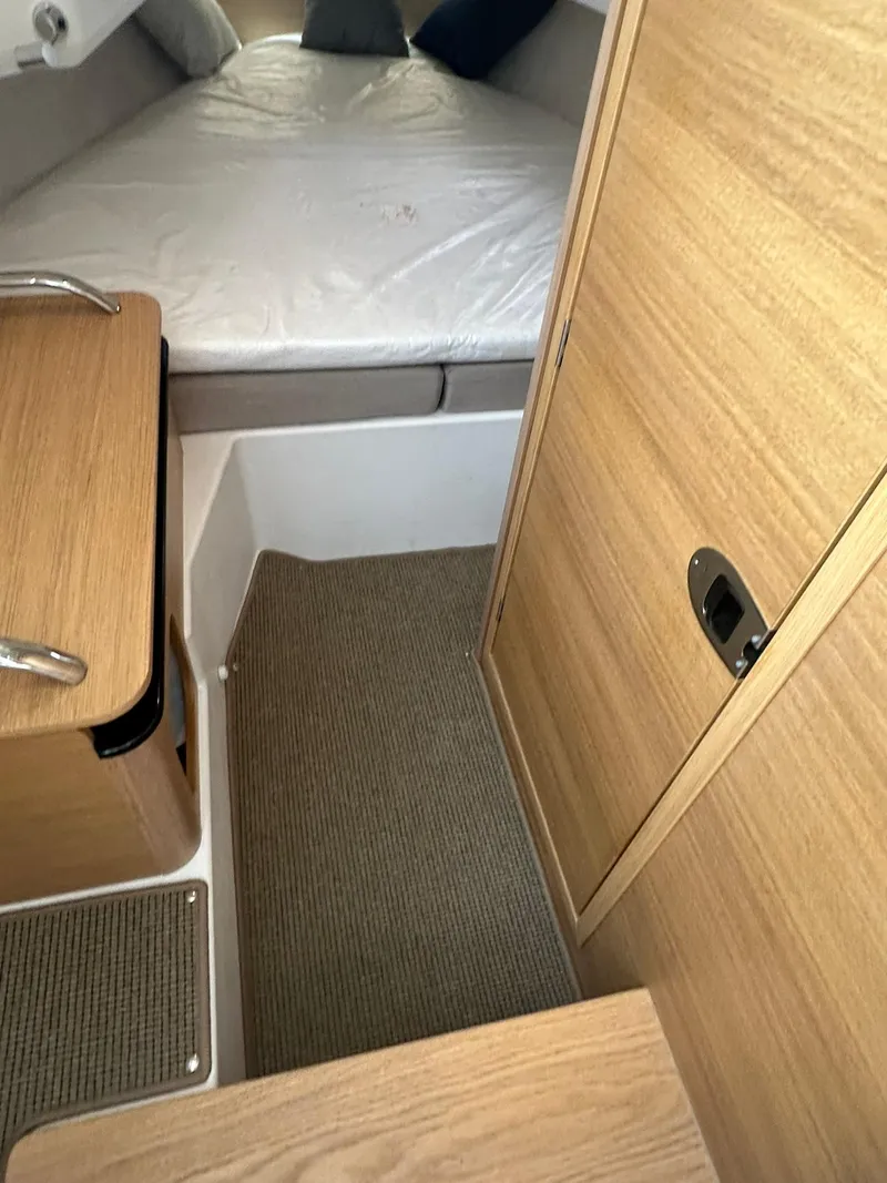 Slide: The Image of 2023 Nimbus Commuter 9 cabin interior with wood finish and cozy sleeping area. - 14
