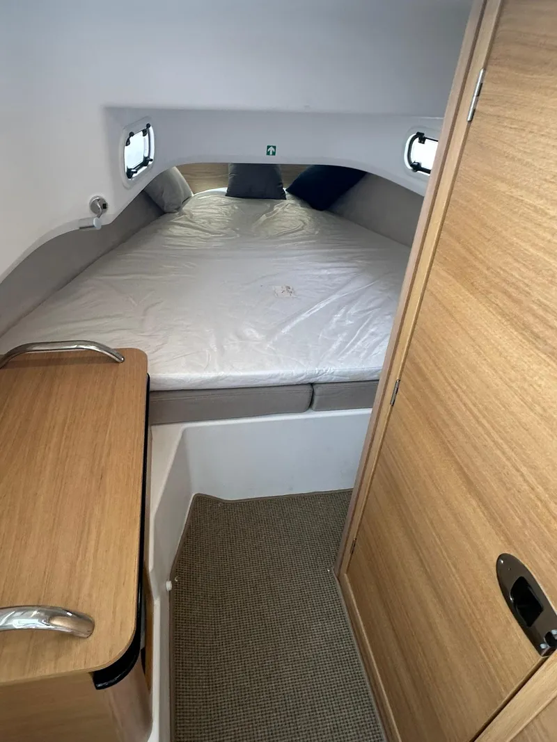 Slide: The Image of 2023 Nimbus Commuter 9 cabin interior with bed and wooden furnishings. - 15