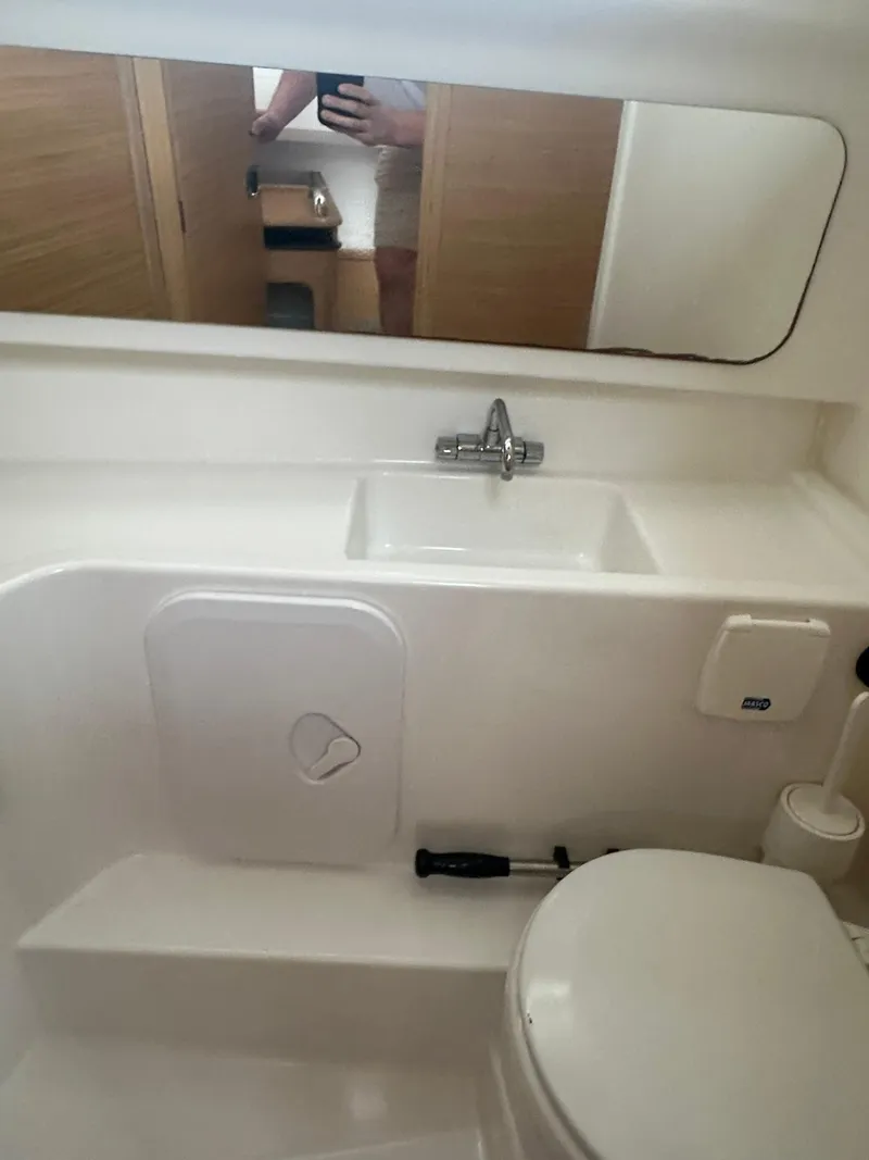 Slide: The Image of 2023 Nimbus Commuter 9 bathroom with sink, mirror, and toilet. - 17