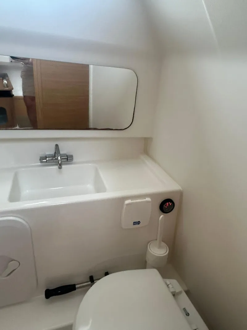 Slide: The Image of 2023 Nimbus Commuter 9 bathroom with sink, mirror, and toilet in compact design. - 18