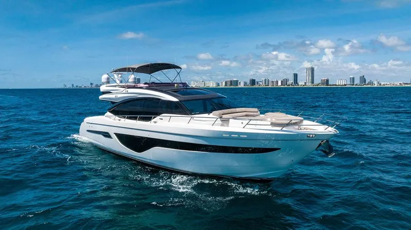 Slide: The Image of Luxurious 2021 Princess S78 yacht cruising on blue ocean with city skyline in background. - 12