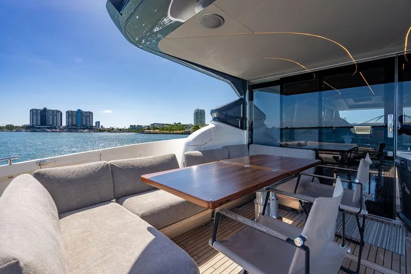 Slide: The Image of Luxurious 2021 Princess S78 yacht deck with seating, table, and waterfront city view. - 15