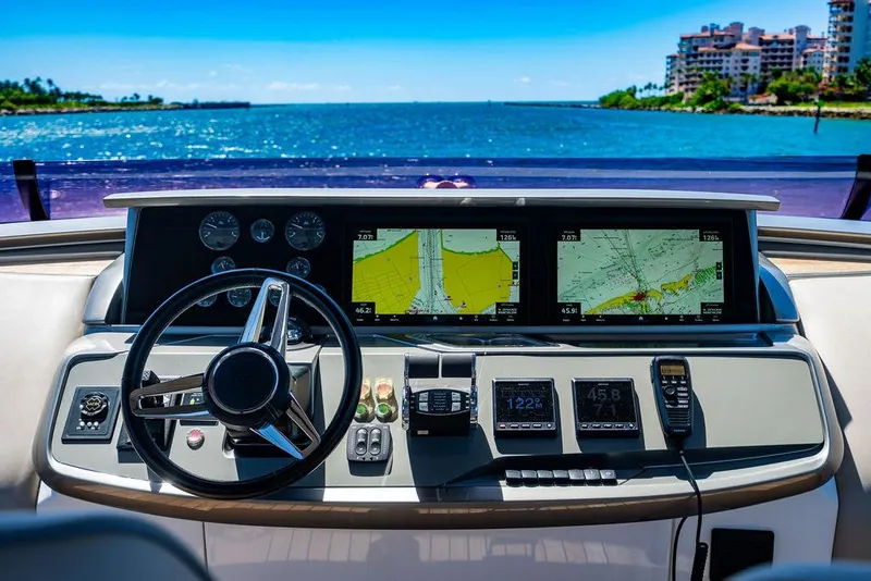 Slide: The Image of Helm of 2021 Princess S78 yacht with navigation screens and controls, overlooking ocean view. - 16
