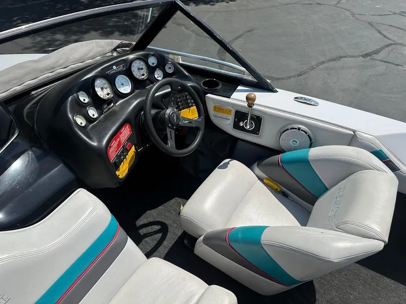 Slide: The Image of 1992 Correct Craft Ski Nautique boat interior with steering wheel and dashboard controls. - 13