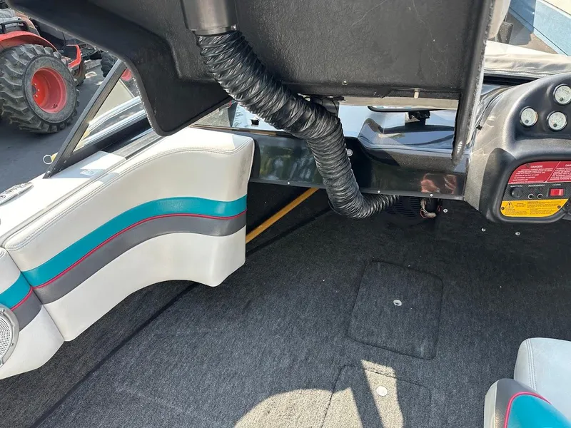 Slide: The Image of 1992 Correct Craft Ski Nautique interior with gray carpet and white seats featuring blue and red accents. - 19