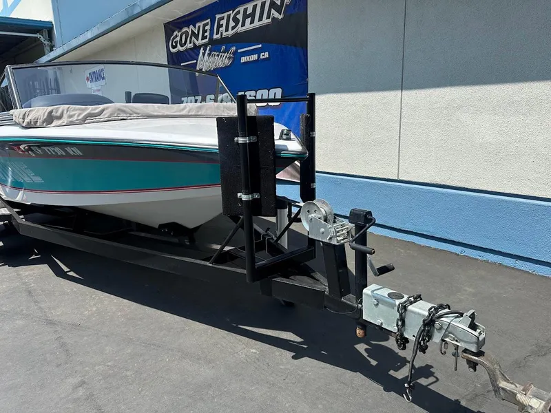 Slide: The Image of 1992 Correct Craft Ski Nautique boat on trailer, parked outdoors. - 2