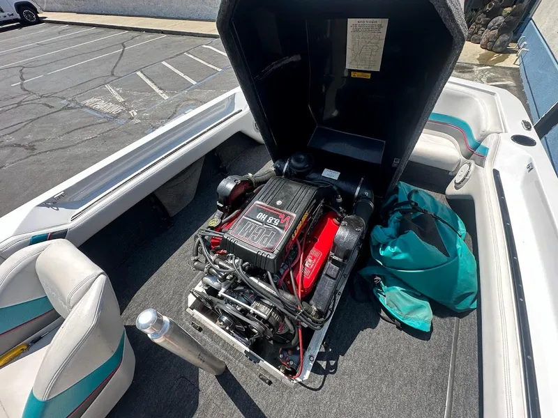 Slide: The Image of 1992 Correct Craft Ski Nautique boat engine compartment with open cover, showing detailed engine view. - 23