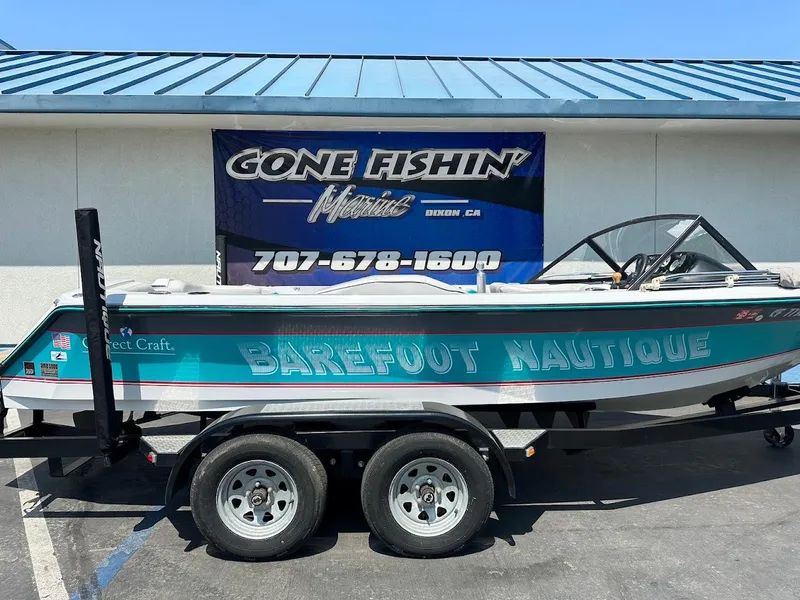 Slide: The Image of 1992 Correct Craft Ski Nautique boat on trailer, parked outside "Gone Fishin'" store. - 4