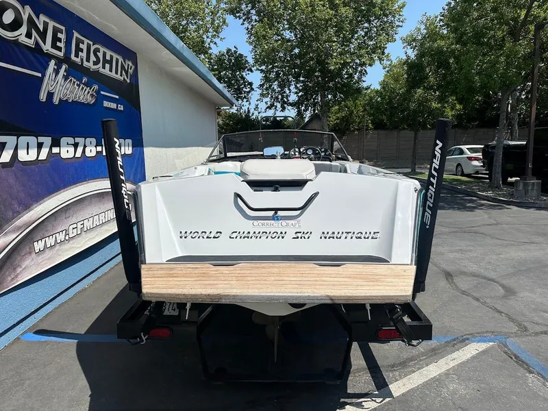 Slide: The Image of 1992 Correct Craft Ski Nautique boat parked outside a marine shop. - 7