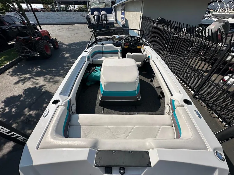 Slide: The Image of 1992 Correct Craft Ski Nautique boat interior with white and teal seating. - 8