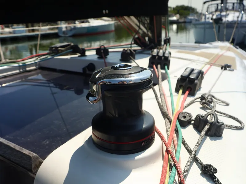 Slide: The Image of Winch and colorful ropes on 2021 Beneteau First 27 SE sailboat deck. - 14