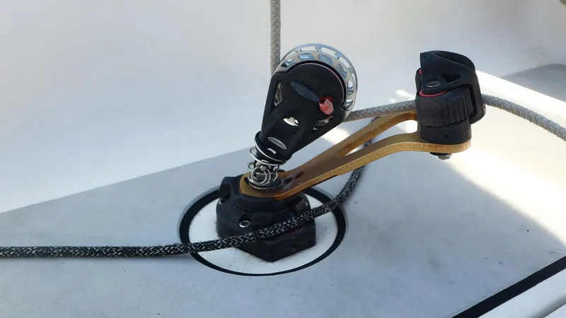 Slide: The Image of Close-up of a Beneteau First 27 SE 2021 sailboat deck fitting and pulley system. - 15