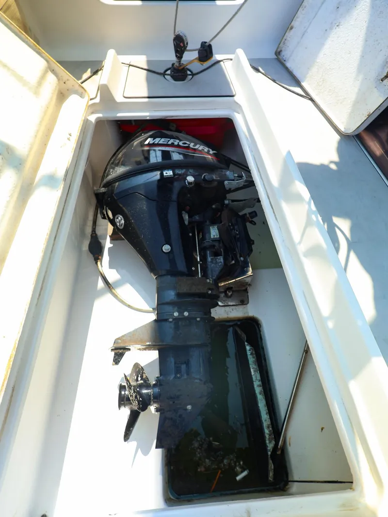 Slide: The Image of Outboard motor in a 2021 Beneteau First 27 SE sailboat compartment. - 17