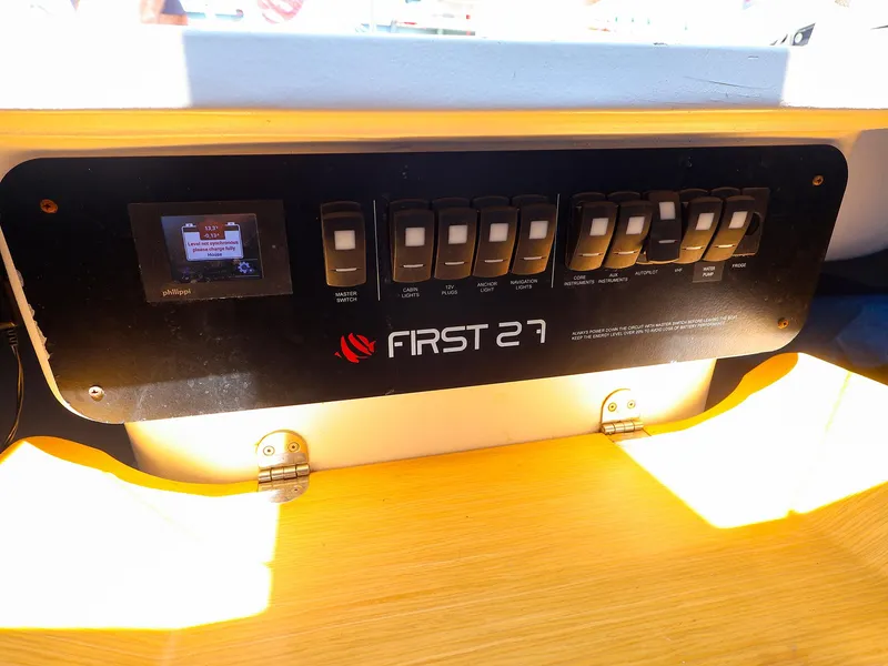 Slide: The Image of Control panel of 2021 Beneteau First 27 SE sailboat with switches and display. - 20