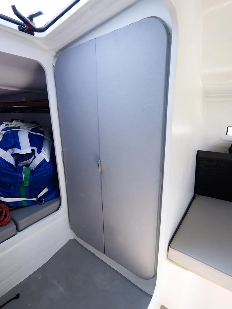 Slide: The Image of Interior of 2021 Beneteau First 27 SE sailboat with storage and seating. - 24