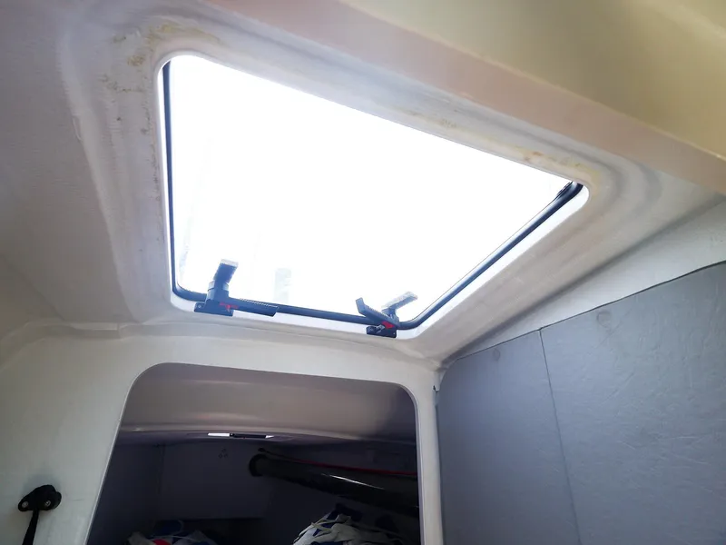 Slide: The Image of Interior view of a 2021 Beneteau First 27 SE sailboat hatch. - 25