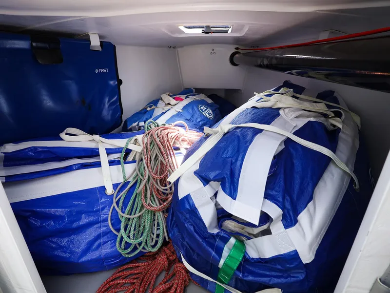 Slide: The Image of Storage compartment of 2021 Beneteau First 27 SE with sailing gear and ropes. - 26