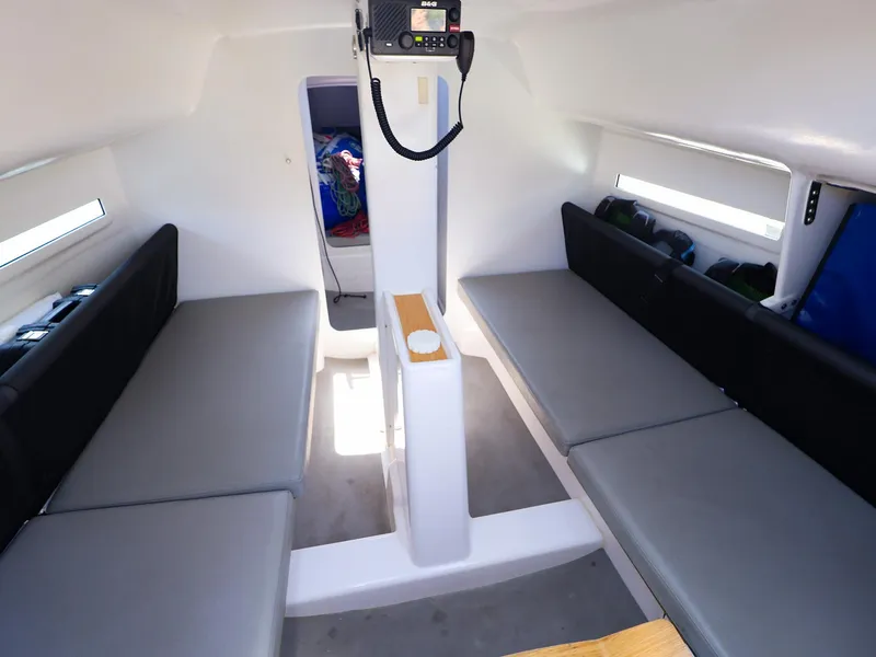 Slide: The Image of Interior of 2021 Beneteau First 27 SE sailboat with seating and storage. - 29