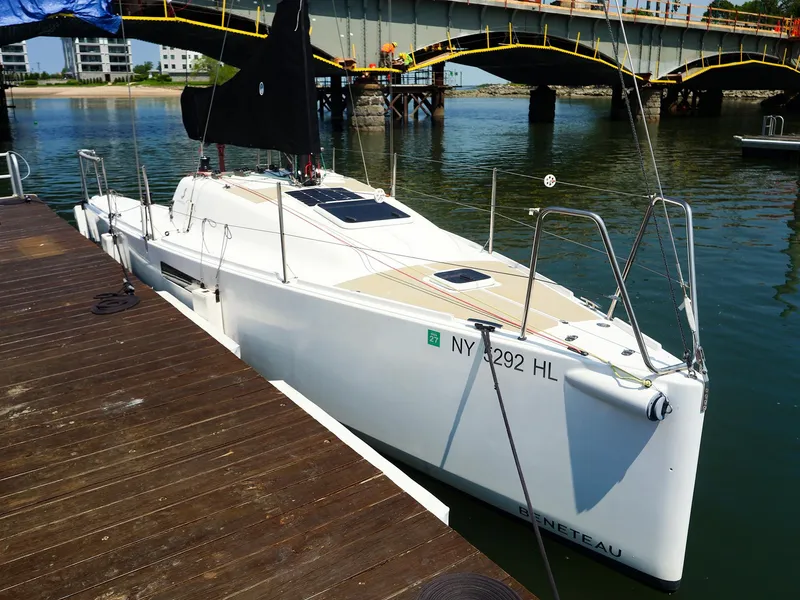Slide: The Image of 2021 Beneteau First 27 SE sailboat docked near a bridge. - 3