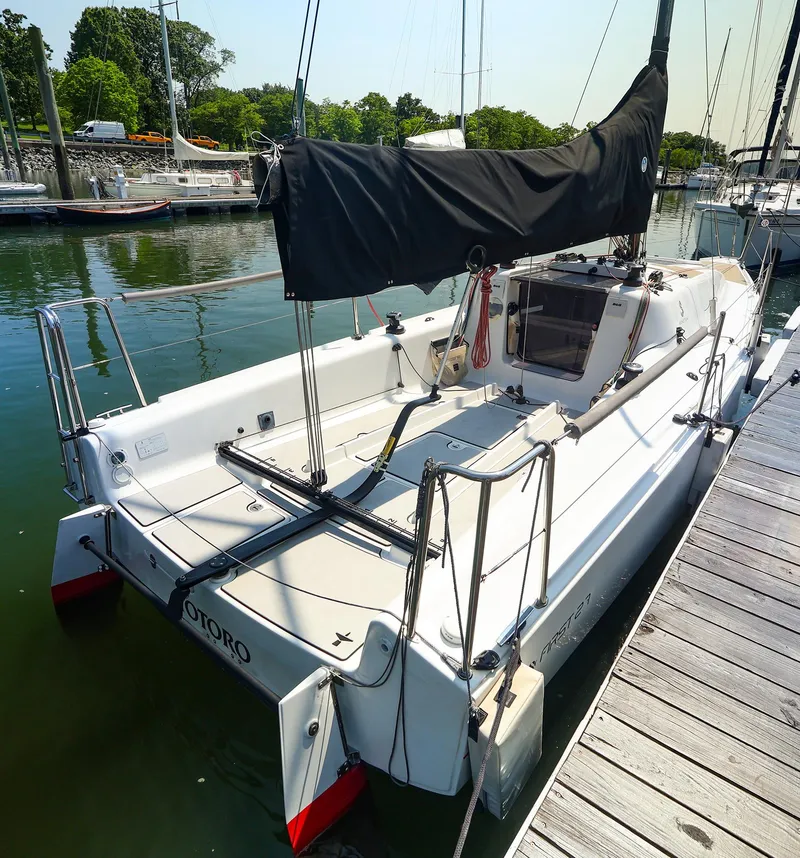 Slide: The Image of 2021 Beneteau First 27 SE sailboat docked at a marina, featuring sleek design and modern rigging. - 6