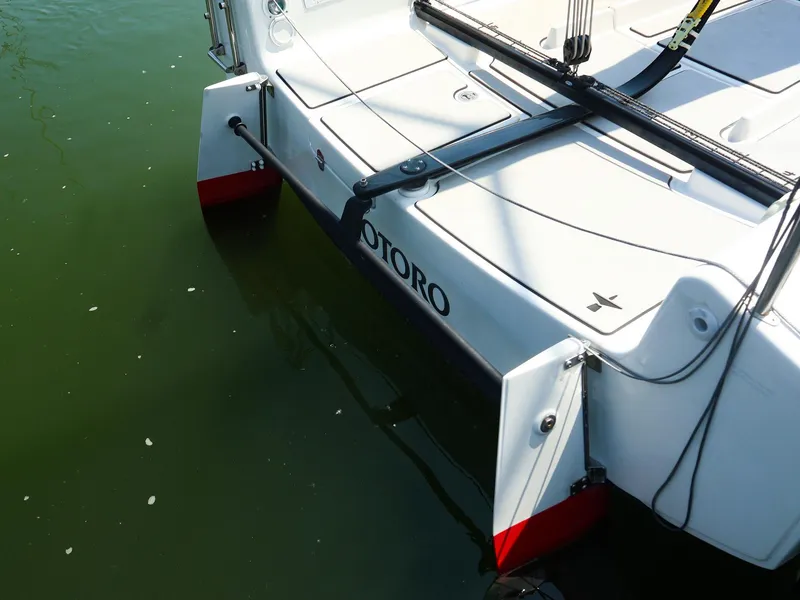 Slide: The Image of Beneteau First 27 SE 2021 sailboat stern view on calm water. - 7