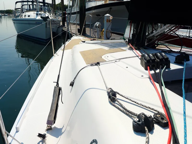 Slide: The Image of 2021 Beneteau First 27 SE sailboat deck with rigging, docked in a marina. - 9