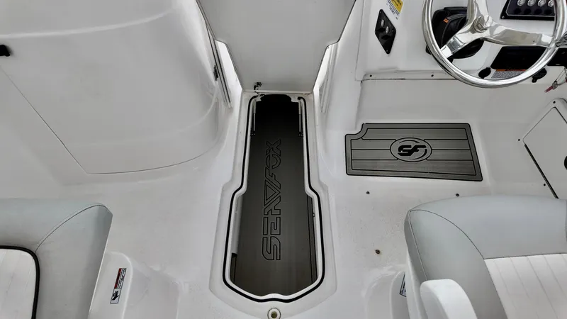 Slide: The Image of 2023 Sea Fox 226 Traveler boat interior with steering wheel and seating area. - 21